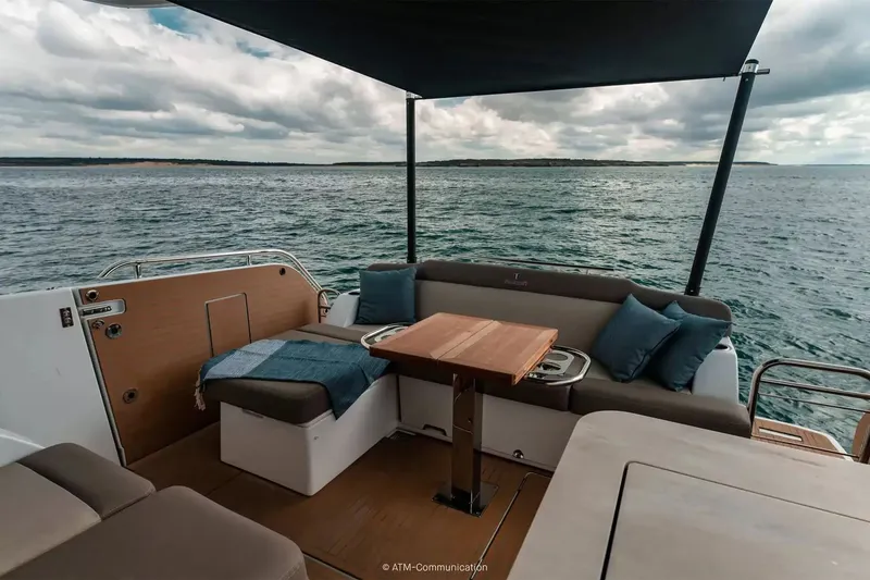 Slide: The Image of The image shows the stern of a Wellcraft 44 Explorer with seating area and table on the water. - 4