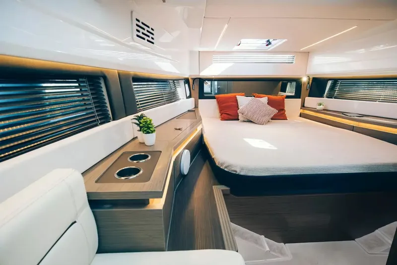 Slide: The Image of The interior of the 2027 Wellcraft 38 Explorer features a modern bedroom with a large bed, stylish pillows, and sleek lighting. - 9