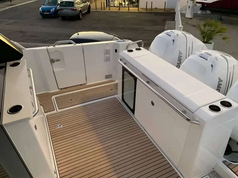 Slide: The Image of The image shows the stern of a Wellcraft 38 Explorer with a wood deck and Mercury engines. - 5