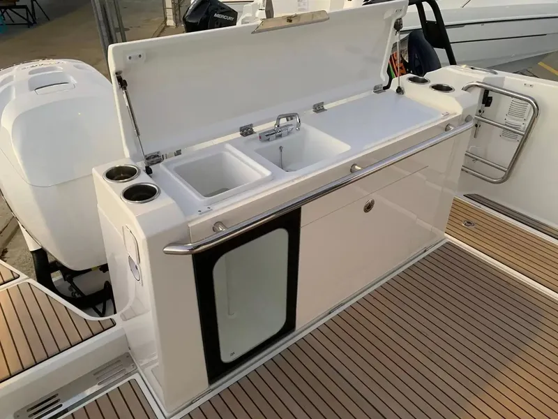 Slide: The Image of The 2027 Wellcraft 38 Explorer features an outdoor kitchen with a sink and storage. - 6