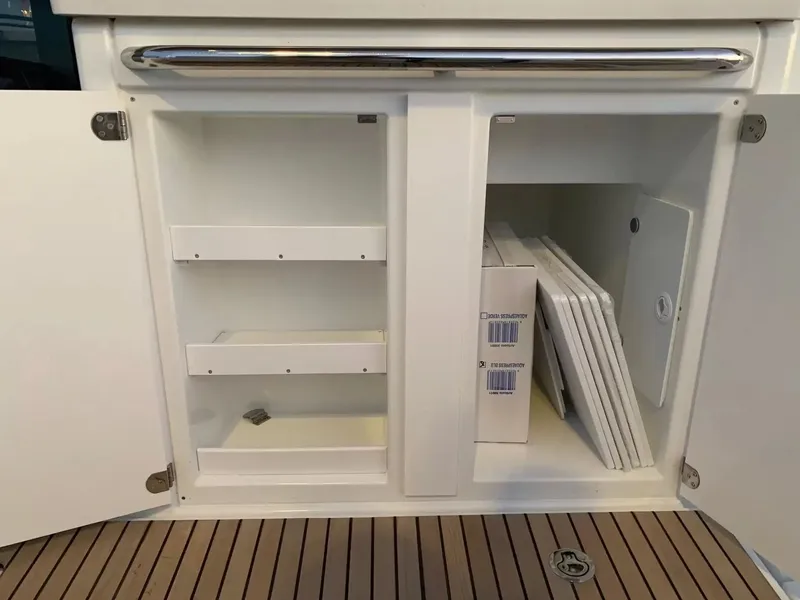 Slide: The Image of An open cabinet on a boat with shelves and stored items. - 7