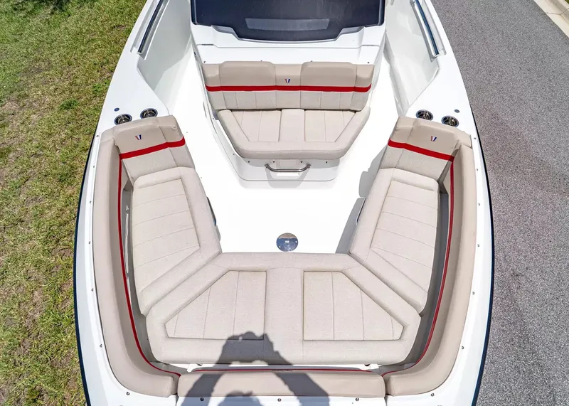 Slide: The Image of The image shows the spacious bow area of a Wellcraft 28 T-Top boat with beige upholstery. - 34