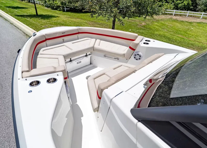Slide: The Image of The image shows the cockpit of a 2027 Wellcraft 28 T-Top boat with beige and red seating. - 28