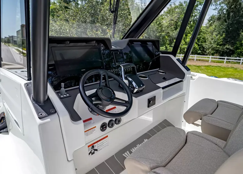 Slide: The Image of The image shows the cockpit of a 2027 Wellcraft 28 T-Top boat with modern instruments and comfortable seating. - 22