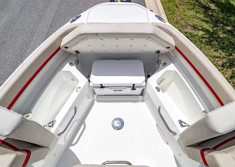 Slide: The Image of The image shows the bow of a Wellcraft 28 T-Top boat with seating and a cooler. - 29