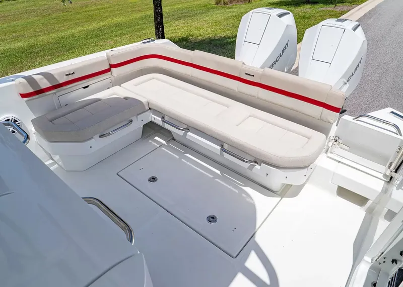Slide: The Image of The image shows the stern of a Wellcraft 28 T-Top boat with beige cushioned seating and two outboard engines. - 6