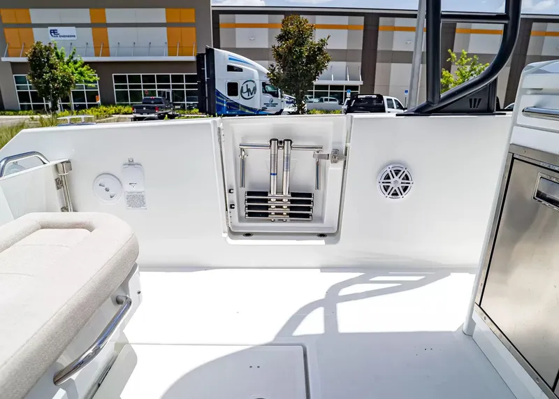Slide: The Image of The image shows the stern of a 2027 Wellcraft 28 T-Top boat. There's a ladder and speakers. - 12