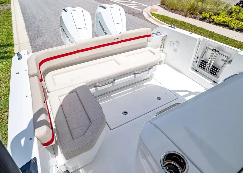 Slide: The Image of The image shows the stern of a 2027 Wellcraft 28 T-Top boat with dual engines and seating area. - 8