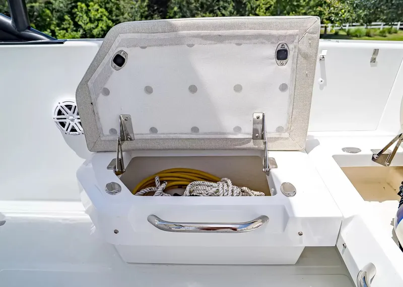 Slide: The Image of An open storage compartment on a Wellcraft 28 T-Top boat reveals ropes and cables. - 11