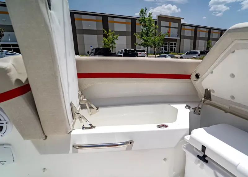 Slide: The Image of The image shows the interior of a 2027 Wellcraft 28 T-Top boat with seating and storage. - 31