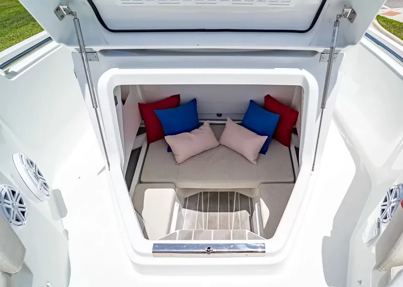 Slide: The Image of The image shows the interior of a Wellcraft 28 T-Top boat with colorful cushions. - 26