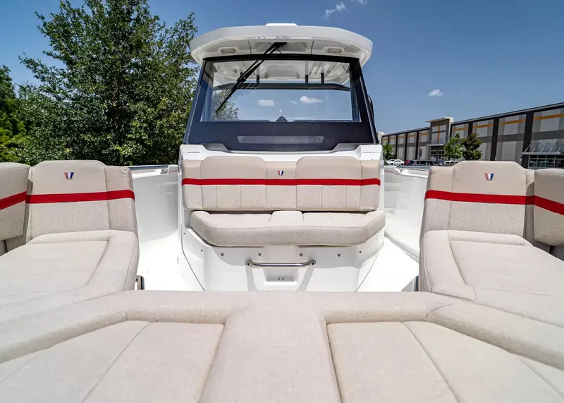 Slide: The Image of The image shows the interior of a 2027 Wellcraft 28 T-Top boat with beige upholstery and red accents. - 33