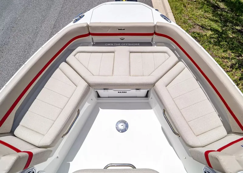 Slide: The Image of The 2027 Wellcraft 28 T-Top features a spacious, cushioned seating arrangement in the bow area. - 35