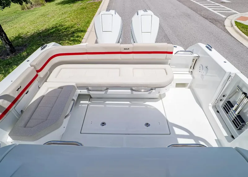 Slide: The Image of The image shows the cockpit of a 2027 Wellcraft 28 T-Top boat with white upholstery and red accents. - 5