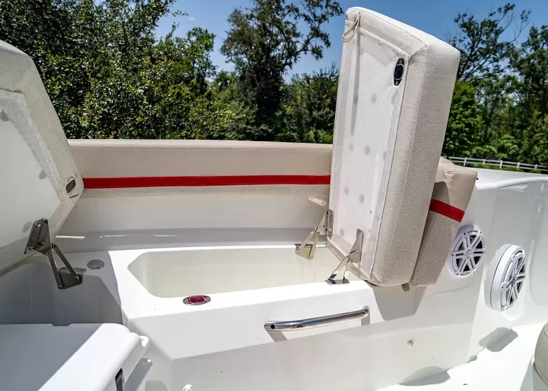 Slide: The Image of The image shows the stern of a Wellcraft 28 T-Top boat with cushioned seats and speakers. - 30