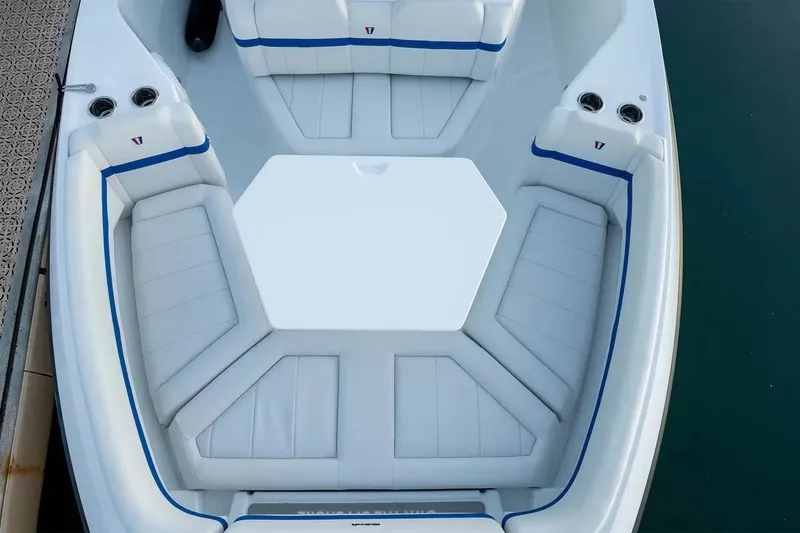 Slide: The Image of Interior view of a modern boat with white upholstery and blue accents. - 21