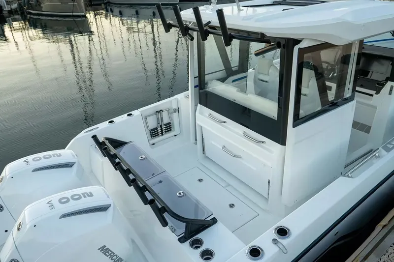 Slide: The Image of The image shows a modern Wellcraft 28 Explorer boat with twin outboard engines at a marina. - 6