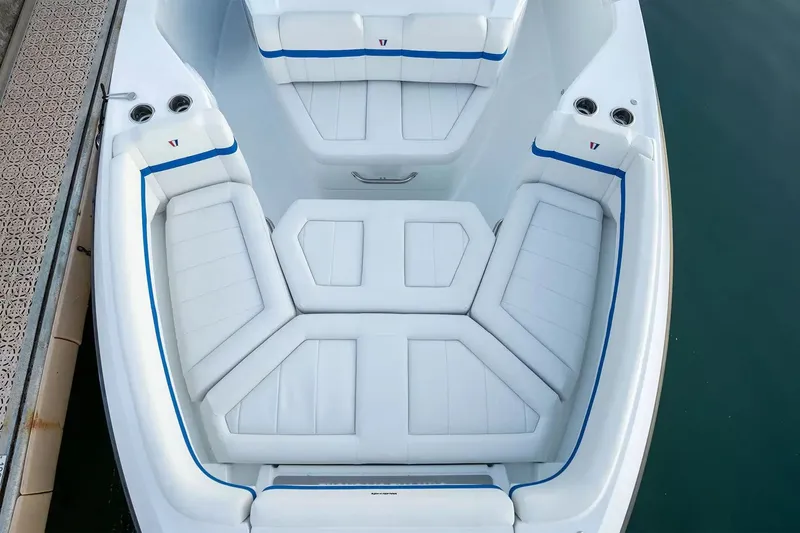 Slide: The Image of The 2027 Wellcraft 28 Explorer features a spacious, cushioned bow area with blue accents. - 20