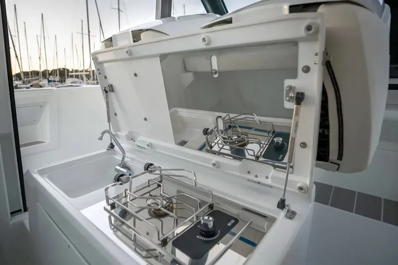 Slide: The Image of The 2027 Wellcraft 28 Explorer features a modern onboard kitchen with two burners and a sink. - 12