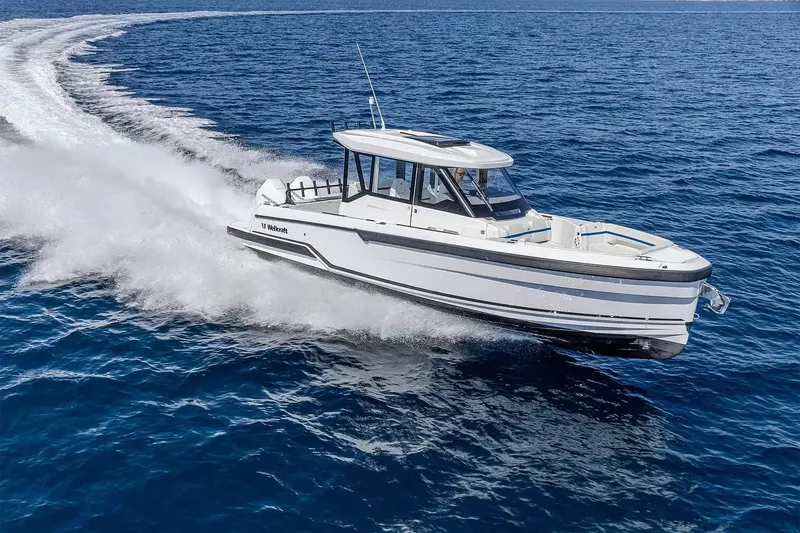 The Image of 2027 Wellcraft 28 Explorer cruising on the water. - 1