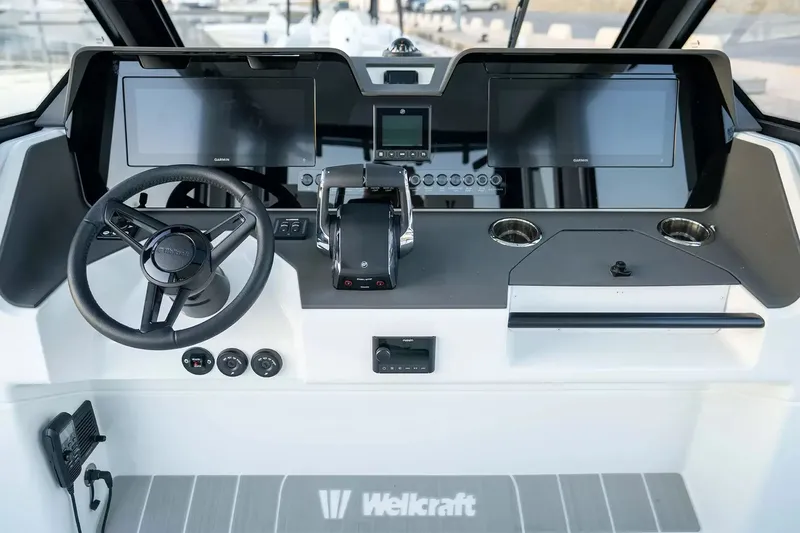 Slide: The Image of The cockpit of the 2027 Wellcraft 28 Explorer with modern instruments and controls. - 10