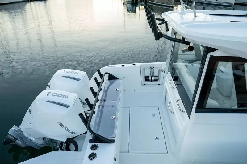 Slide: The Image of The image shows a modern boat with twin outboard engines docked in a harbor. - 4