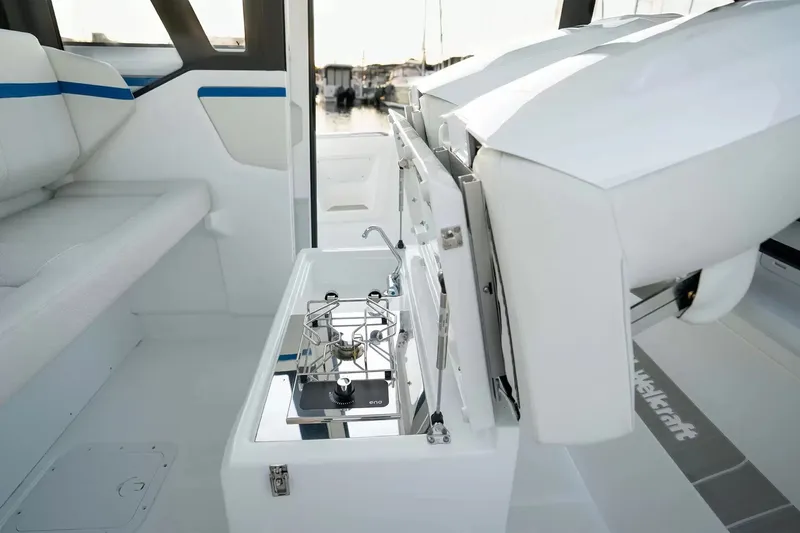 Slide: The Image of Interior view of a modern Wellcraft 28 Explorer with a small kitchenette and seating area. - 13