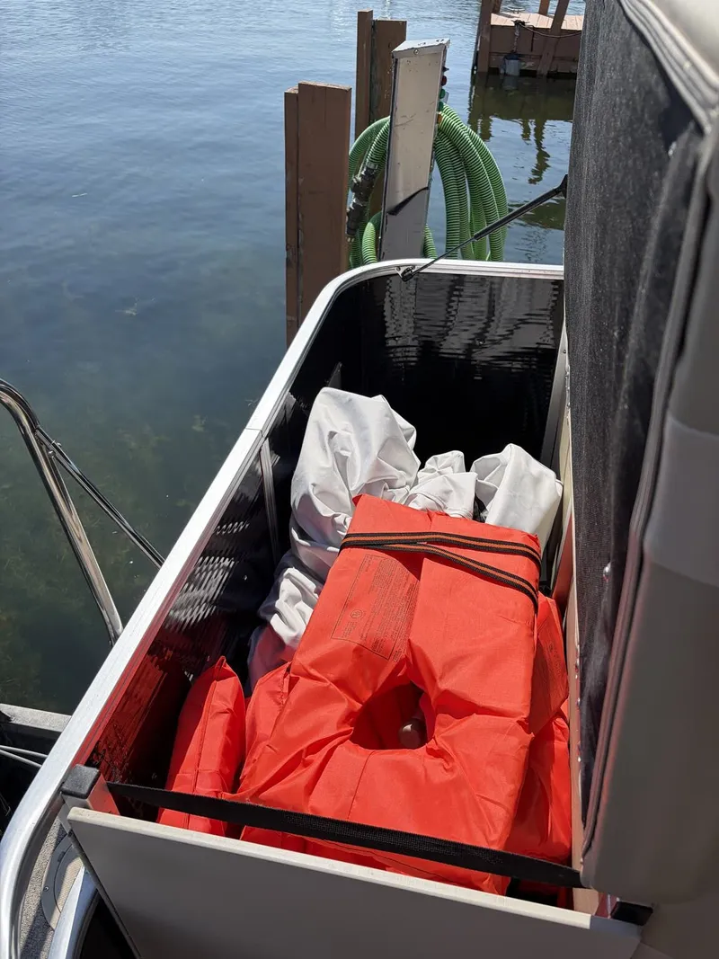 Slide: The Image of A storage compartment on a boat with life jackets and other items. - 9