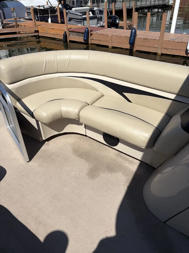 Slide: The Image of A beige upholstered seating area on a boat docked at a pier. - 5