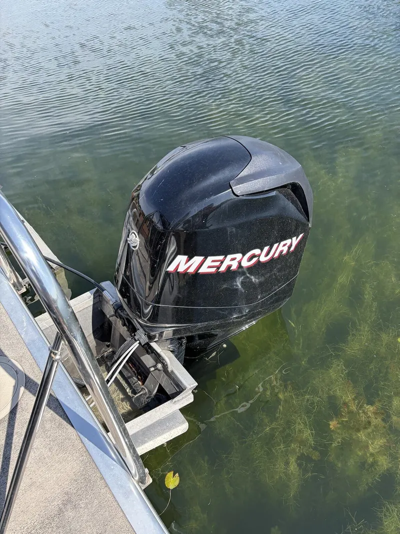 Slide: The Image of A Mercury outboard motor on a boat in calm water. - 8