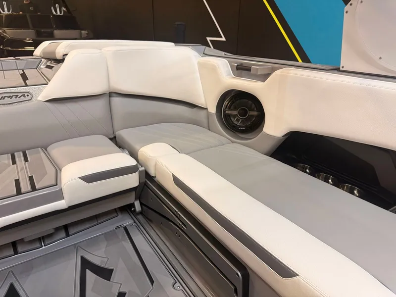 Slide: The Image of Interior of a 2022 Supra SA boat with gray and white upholstery and a speaker. - 12