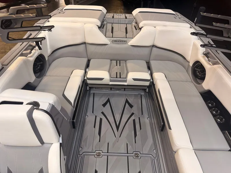 Slide: The Image of Interior of a 2022 Supra SA boat with gray and white upholstery and modern speakers. - 7