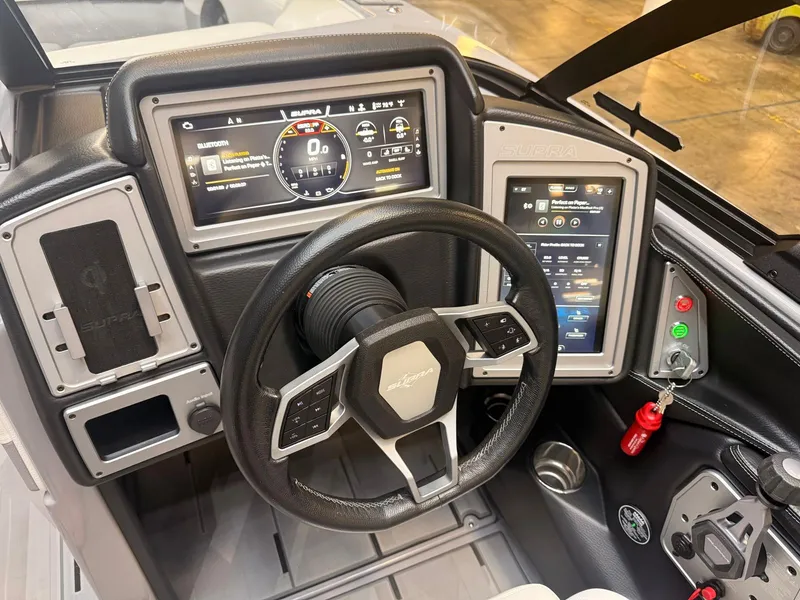 Slide: The Image of The image shows the dashboard of a Supra SA boat with modern digital displays. - 8