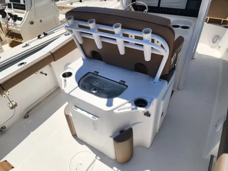 Slide: The Image of The image shows the cockpit of a Sea Hunt Ultra 265 SE boat with fishing rod holders. - 8