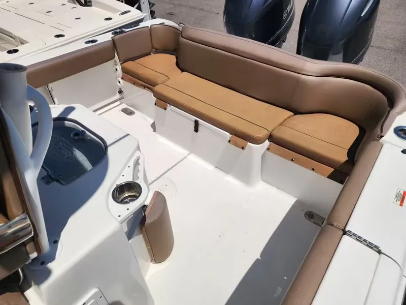 Slide: The Image of The image shows the cockpit of a 2021 Sea Hunt Ultra 265 SE boat with beige seating. - 6