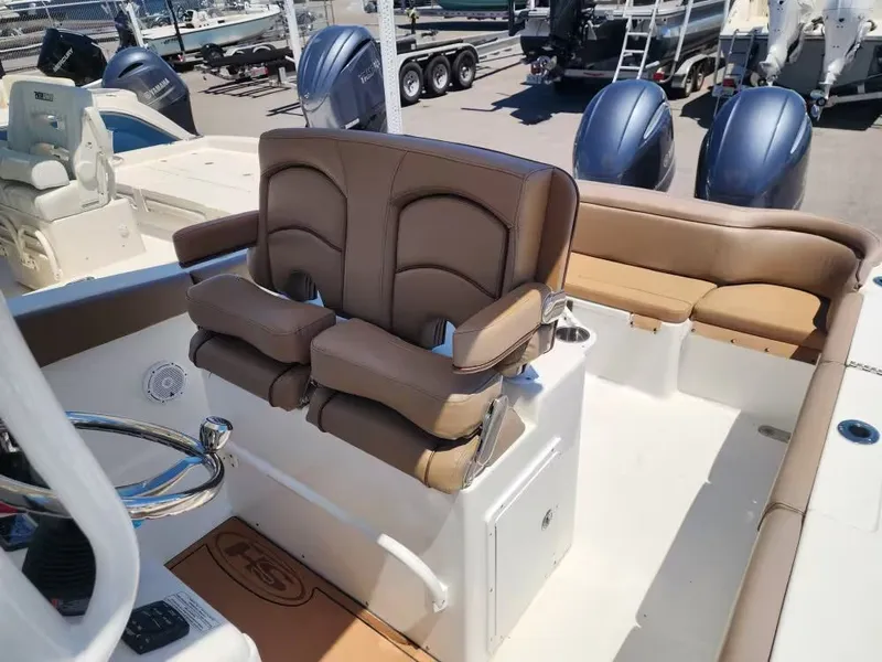 Slide: The Image of The image shows the cockpit of a Sea Hunt Ultra 265 SE boat with beige seating. - 9