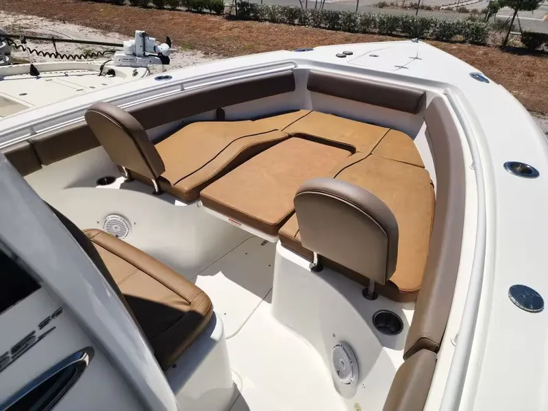 Slide: The Image of The image shows the bow area of a 2021 Sea Hunt Ultra 265 SE boat with cushioned seating. - 12