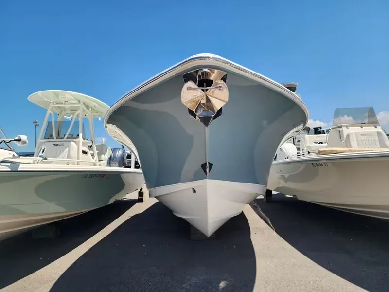 Slide: The Image of A 2021 Sea Hunt Ultra 265 SE boat is on land between other boats. - 5