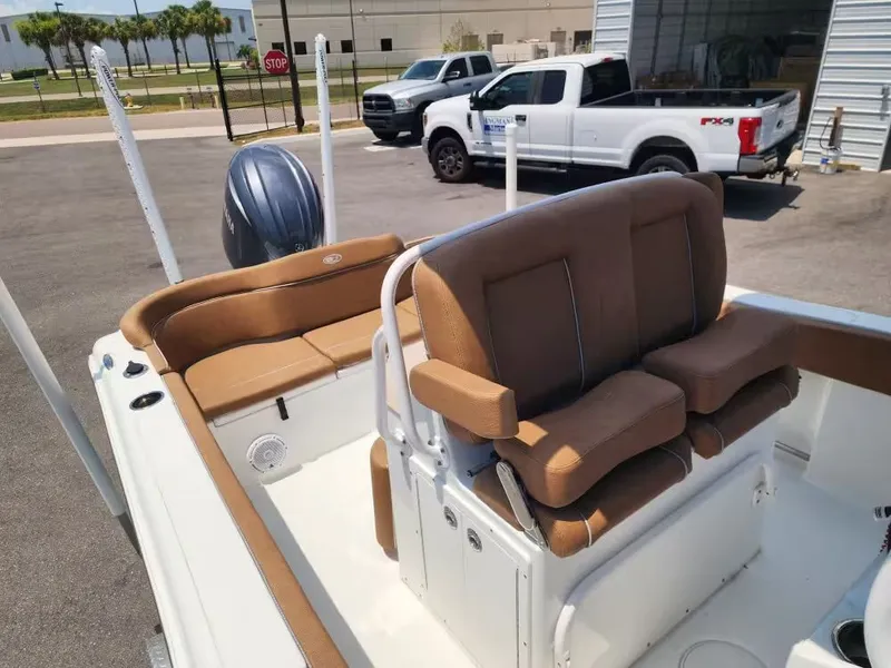 Slide: The Image of The image shows the cockpit of a Sea Hunt Ultra 234 boat with brown seating. - 10