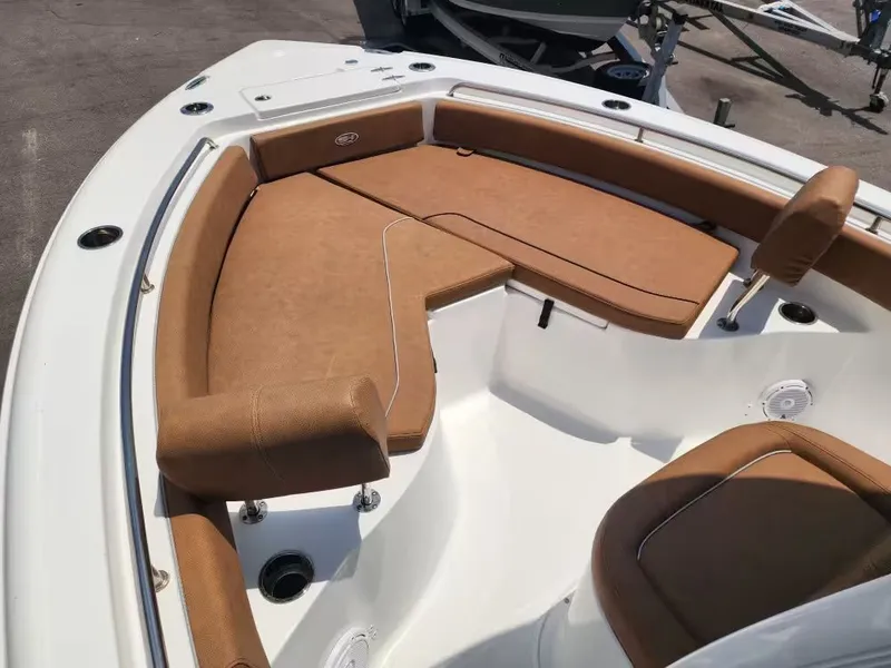 Slide: The Image of The image shows the bow area of a Sea Hunt Ultra 234 boat with brown cushions. - 13