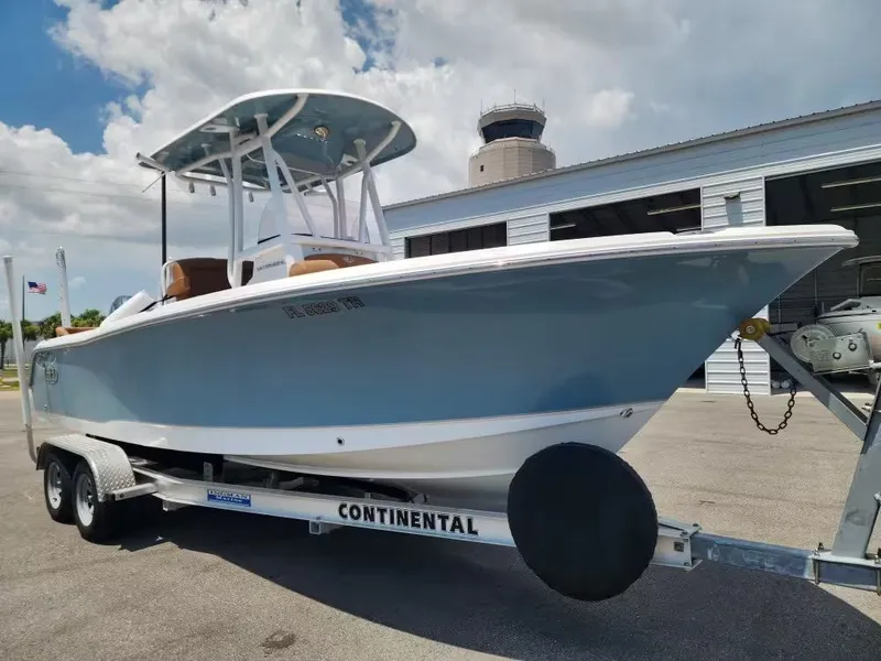 Slide: The Image of A 2024 Sea Hunt Ultra 234 boat on a trailer in front of a building. - 3