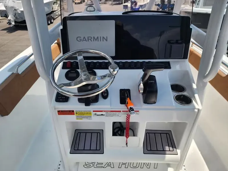Slide: The Image of The image shows the helm of a Sea Hunt Ultra 234 boat with Garmin navigation. - 11