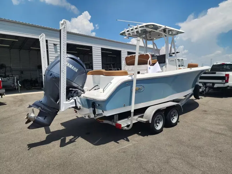 Slide: The Image of A 2024 Sea Hunt Ultra 234 boat on a trailer, featuring a Yamaha outboard motor. - 5
