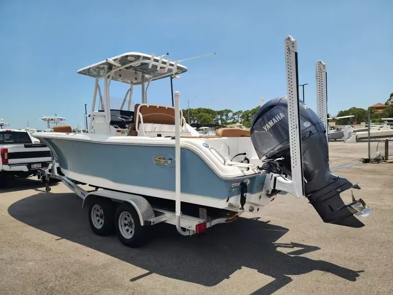 Slide: The Image of A 2024 Sea Hunt Ultra 234 boat on a trailer, featuring a Yamaha outboard motor. - 4