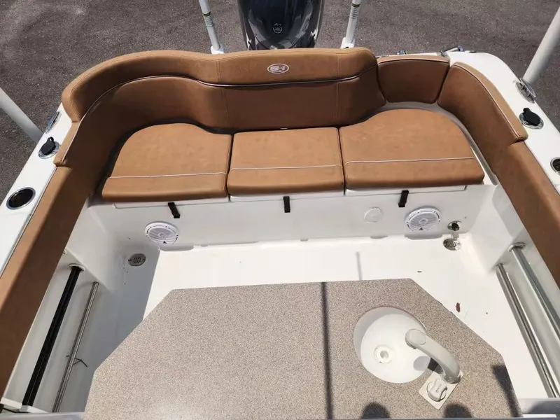 Slide: The Image of The image shows the seating area of a 2024 Sea Hunt Ultra 234 boat with brown upholstery. - 8