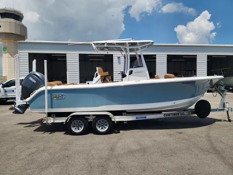 The Image of 2024 Sea Hunt Ultra 234 on a trailer, parked in front of a building. - 1