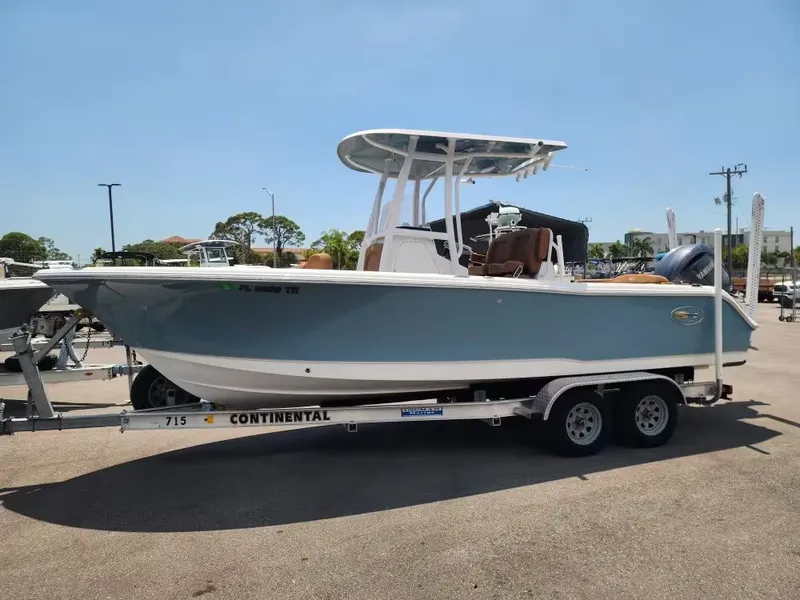 Slide: The Image of A 2024 Sea Hunt Ultra 234 boat on a trailer outdoors. - 2