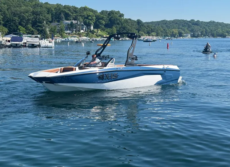 The Image of 2026 Axis A225 on a calm lake with wooded shores in the background. - 1
