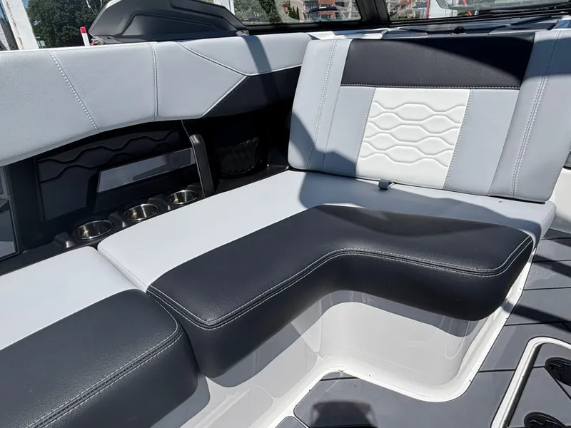 Slide: The Image of The interior of the 2026 Malibu Wakesetter 23 LSV features stylish, cushioned seating in black and white. - 884