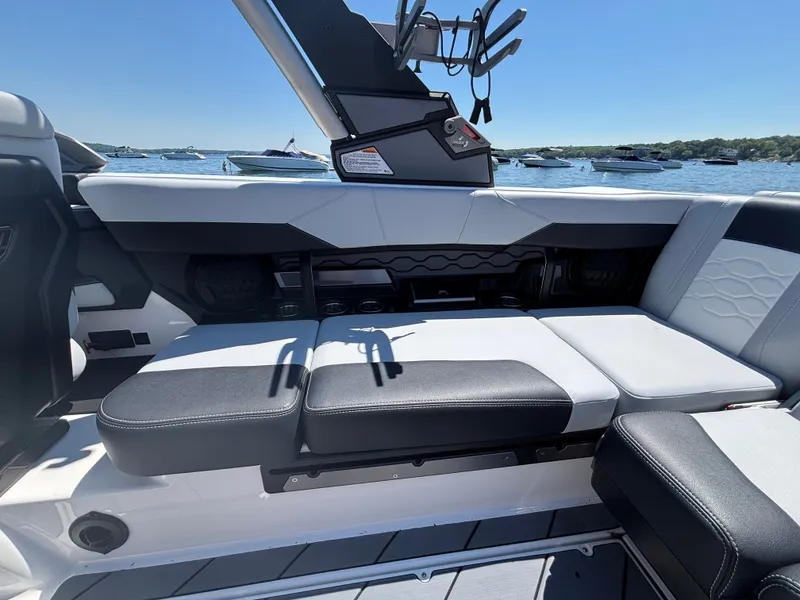 Slide: The Image of The image shows the interior of a Malibu Wakesetter 23 LSV with stylish seating and clear skies. - 886